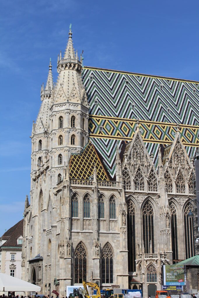 Stephansdom Wien mit buntem Zickzack-Ziegeldach vor blauem Himmel