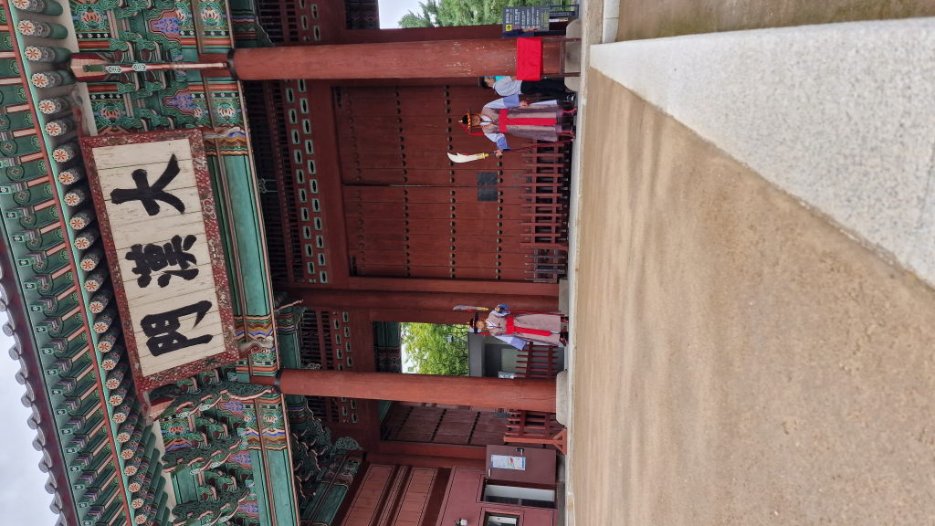 Palastgebäude Deoksugung durch Bäume mit modernem Gebäude dahinter