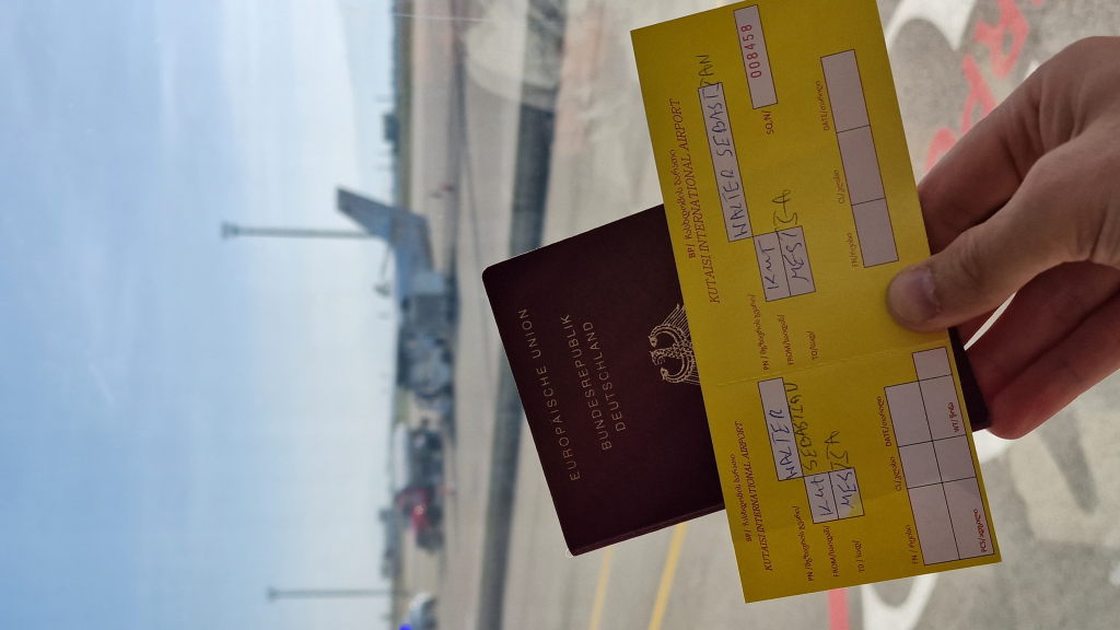 Handgeschriebenes gelbes Ticket Kutaisi-Mestia mit deutschem Reisepass